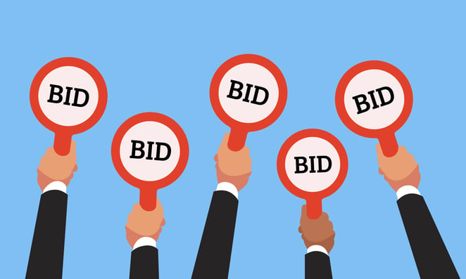 arms holding up bid signs